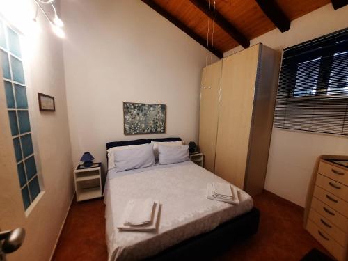 a small bedroom with a bed and a window at LA CASA DI MARTA in Milazzo