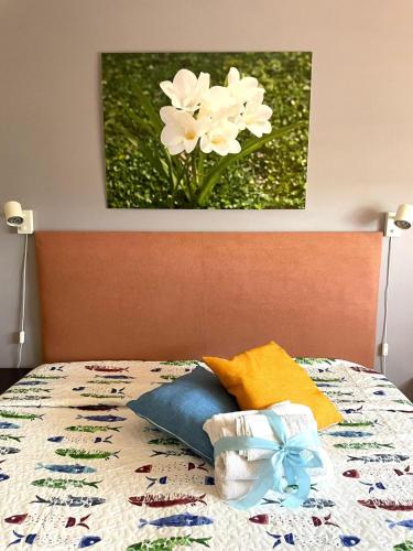 a bed with a picture of flowers on it at La Fresia Bianca in Sciacca