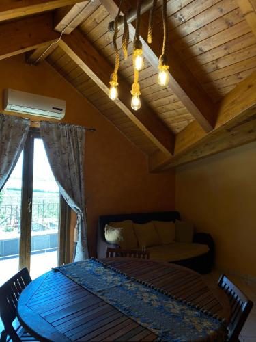 a living room with a table and chairs and a couch at beucarnea apartment salerno in Eboli