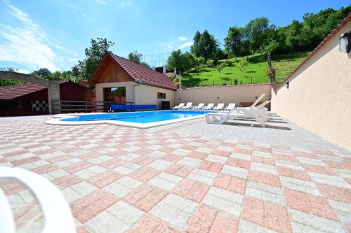 a patio with a swimming pool in a house at Marginimea Sibiului - Pensiunea Darian & David in Orlat