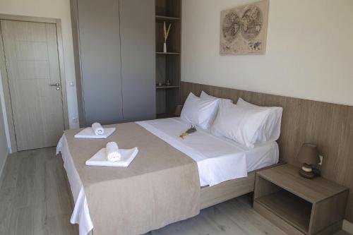 a bedroom with a bed with two towels on it at Allure Apartments in Ulcinj