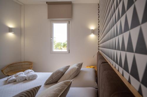 a bedroom with a bed and a window at Macchia Piccinna in Maruggio