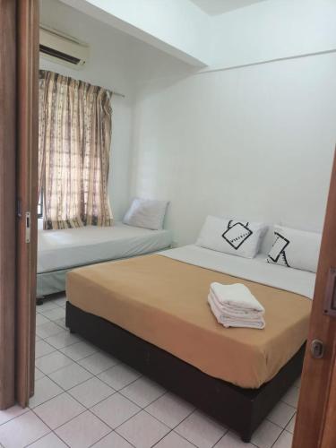 a bedroom with two beds and a window at Port Dickson Seaview Homestay in Port Dickson
