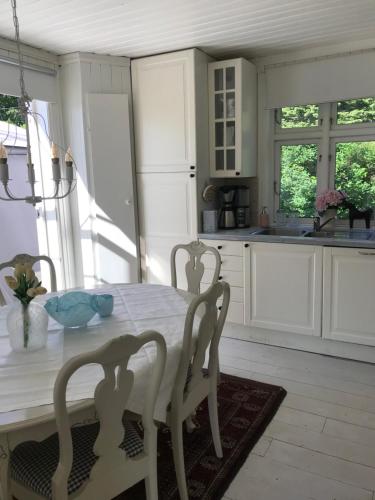 a kitchen with a table and chairs in a room at Småbruket stall solheim in Rødby