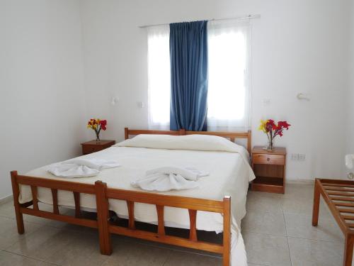a bedroom with a bed with two towels on it at Kozis Hotel Apartments in Polis Chrysochous