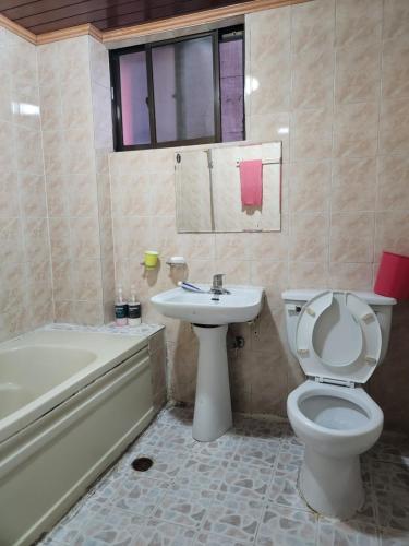a bathroom with a toilet and a sink and a tub at Daeho Motel in Busan