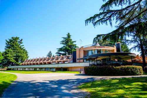 a large building with a road in front of it at Hotel Pineta in Busto Arsizio