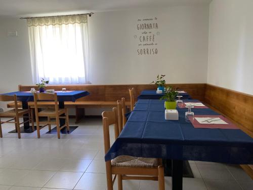 a dining room with blue tables and chairs at B&B Stari Mlin - Vecchio Mulino in San Giorgio