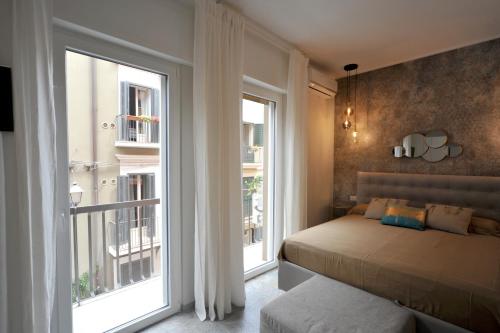 um quarto com uma cama e uma grande janela em Suite107 em Bari