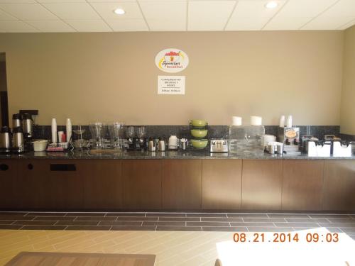 a bar in a restaurant with a counter at Super 8 by Wyndham Hershey Chocolate Avenue in Hershey