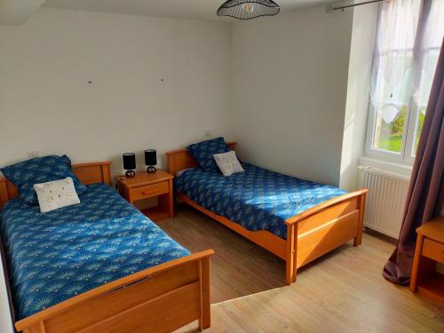 a bedroom with two beds and a window at Gîte Chez Cheynaud in Celles