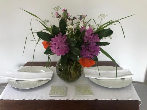 a vase of flowers sitting on a table with napkins at Brylach Steading in Aberlour
