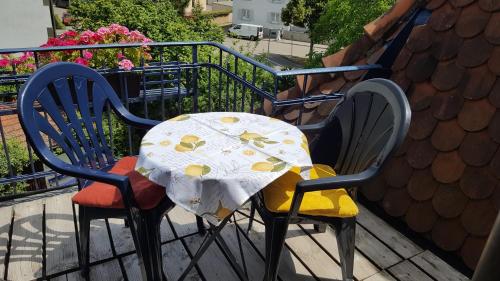 a table and chairs sitting on a balcony at Villa Am Rosenfelspark in Lörrach