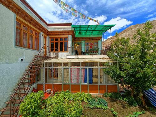 a house with a balcony on top of it at YANG-LHA GUEST HOUSE in Leh