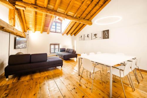 a living room with a couch and a table at Alp Apartments - Xavier in Aosta