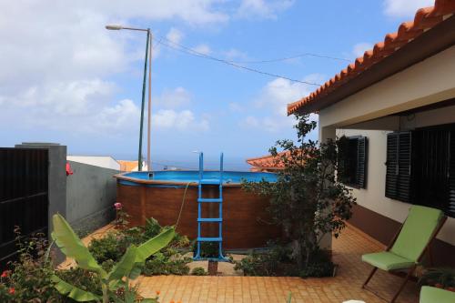 a ladder next to a swimming pool in a house at Suites Pinto Coelho in Caniço