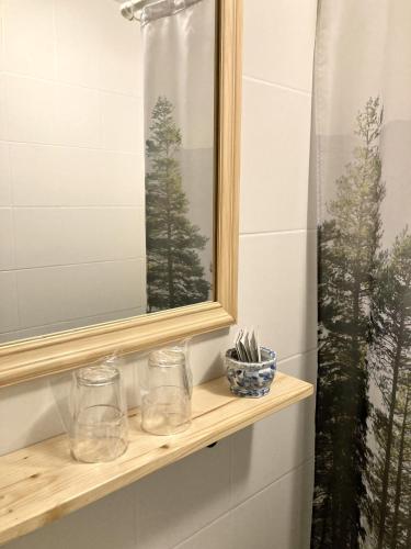 a bathroom with a window and a shelf with glasses at Vila Dunavski Raj in Golubac
