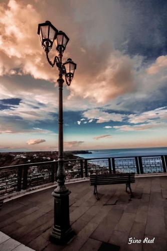 a street light and a bench on a pier at B&B AcquaViva in Marina San Vito