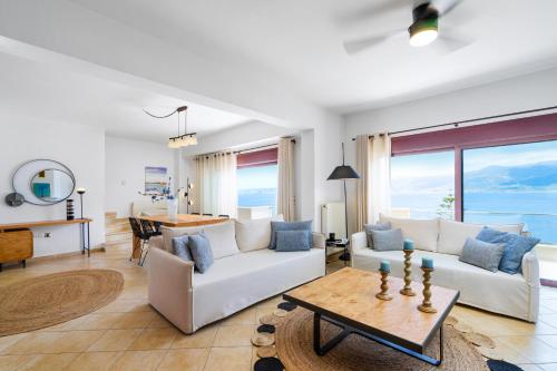 a living room with a white couch and a table at Artemis ΙnCreteble Cretan Resindences Collection in Sitia