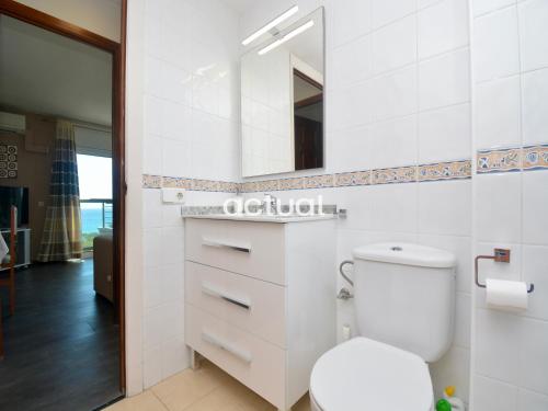 a bathroom with a white toilet and a mirror at Fanals 4M in Platja d'Aro