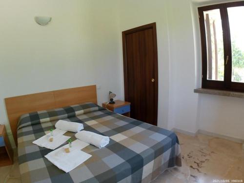 a bedroom with a bed with two towels on it at Terrae Eremis: Ristorante, Bar, B&B in Roccamorice