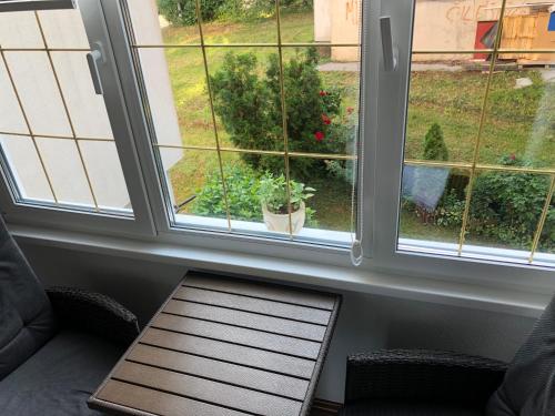 a room with a window with a table in front of it at Welcome to the Apartment Mesic- Airport Sarajevo in Sarajevo