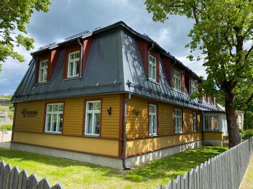 a wooden house with a black roof at Verona Apartments - Paide in Paide