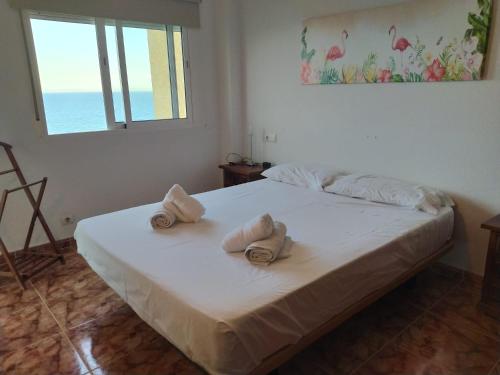 En eller flere senger på et rom på Olimpo Playa Carvajal