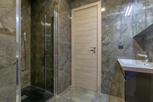 a bathroom with a shower and a sink at Empress apartment in Split