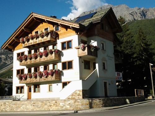 a building with flower boxes on the balconies at Residence Pedranzini in Bormio