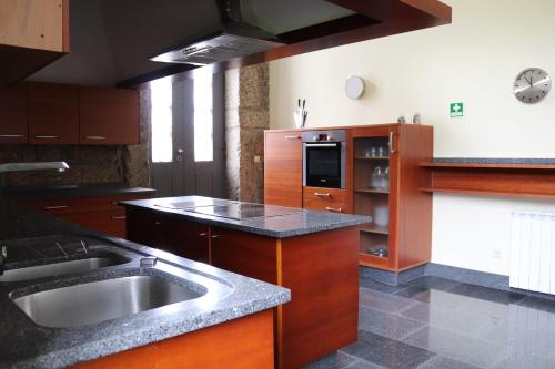 a kitchen with a sink and a counter top at Quinta da Presa in Vermoim