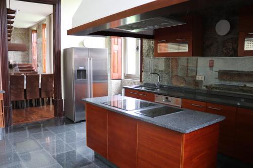 a kitchen with a stainless steel refrigerator and a counter top at Quinta da Presa in Vermoim