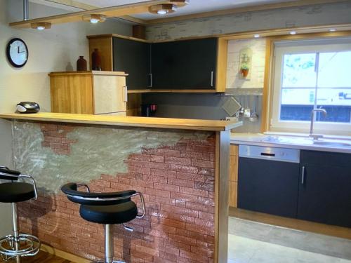 a kitchen with a sink and a counter with a stool at Moselweinlaub in Bruttig-Fankel