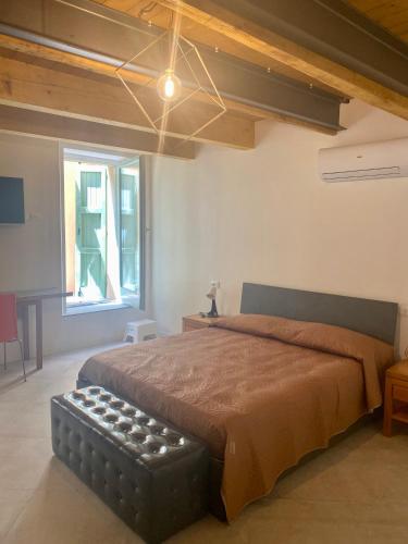 a bedroom with a large bed and a window at Residence La MARCHINA in Castel Bolognese