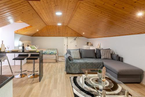 a living room with a couch and a table at Casa Miradouro do Pigarro, Sunny Apartment in Calheta