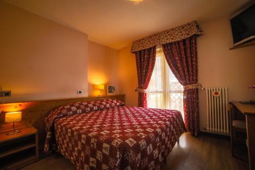 Postel nebo postele na pokoji v ubytování Albergo Punta Zerbion