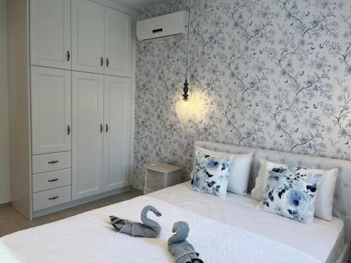 a bedroom with a bed with two swans on it at Reginas Studios & Apartments- Blue Flower apartment in Fiskardho