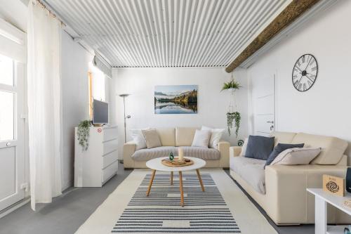 a living room with a couch and a table at Waterview Apartments - Koru Apartment and pool in Mimice