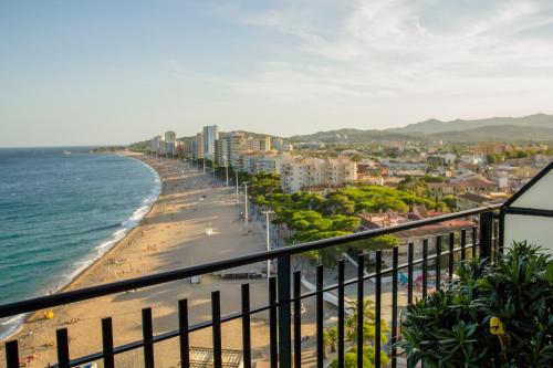 a view of the beach from the balcony of a building at Spacious seafront apartment in Platja d'Aro
