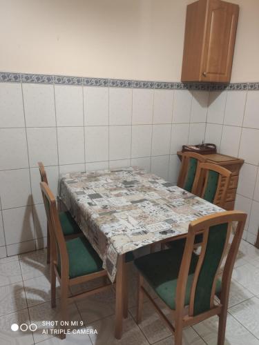 a table in a kitchen with a table and chairs at Apartments Domovik ,Kirilla i Mefodiya, 5 in Mukacheve