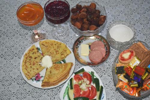 a table topped with plates of food and bowls of food at Guest House Oimo in Balykchy