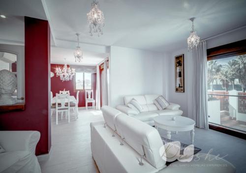 a living room with a white couch and a table at PUSHE Village Playa Granada Beach & Golf 1 in Motril
