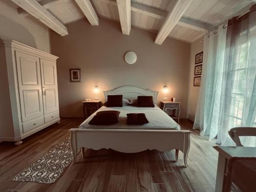 a bedroom with a large bed and a large window at b&b Tenuta il Molino in Quercianella