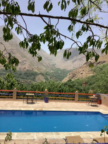 a swimming pool with a view of a mountain at Jnane Karma in Imlil