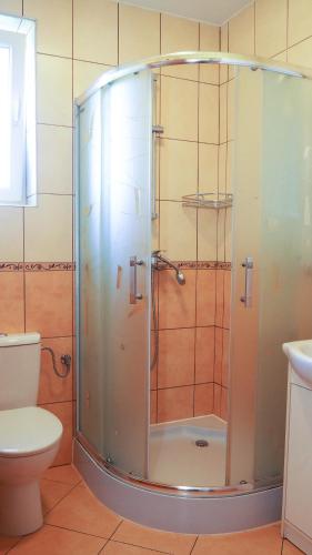 a shower with a glass door in a bathroom at Willa Arkadia in Władysławowo