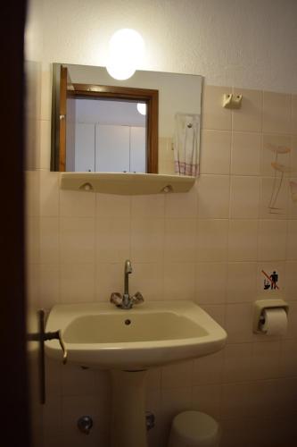 a bathroom with a sink and a mirror at Alexander in Pefkochori