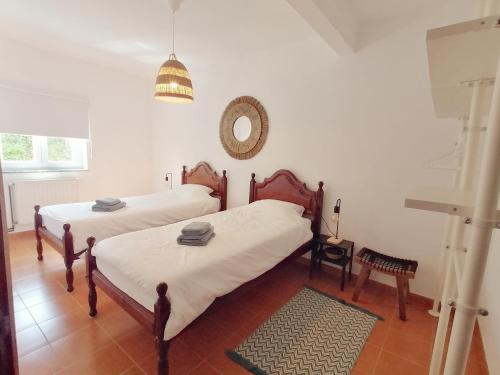 a bedroom with two beds and a mirror on the wall at Pine 3 Inn, holiday home, activities and more in Boavista dos Pinheiros