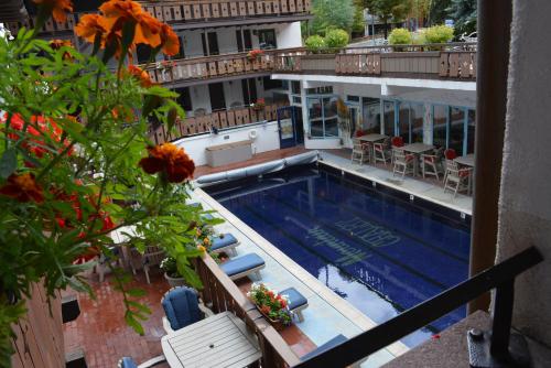 a view of a swimming pool from a balcony at Mountain Chalet Aspen in Aspen