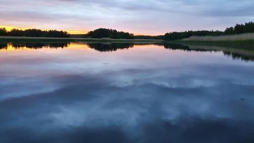 a view of a lake at sunset at Björnbyn Stugby in Råda