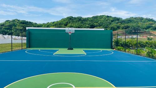 a court with a basketball hoop on a tennis court at Aquamarine Resort-style Vacations in Lucea